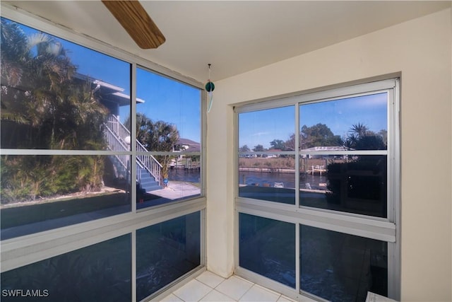 unfurnished sunroom with a water view