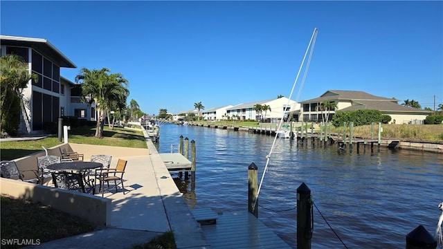 dock area featuring a water view and a residential view