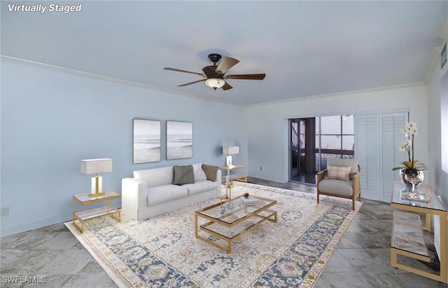 living area with ceiling fan, ornamental molding, and baseboards
