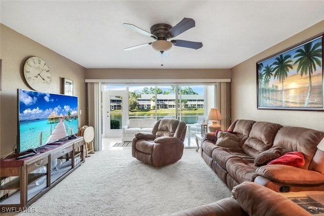 carpeted living room with ceiling fan