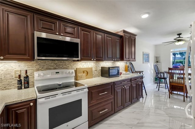 kitchen featuring decorative backsplash, a ceiling fan, stainless steel microwave, marble finish floor, and white electric range