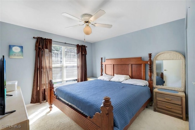 bedroom featuring a ceiling fan and light carpet