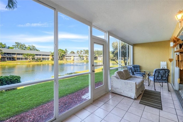 sunroom / solarium featuring a water view and plenty of natural light