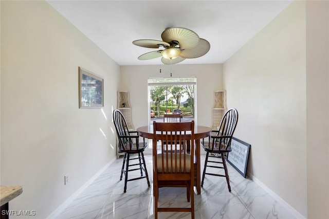 dining space with marble finish floor, baseboards, and a ceiling fan