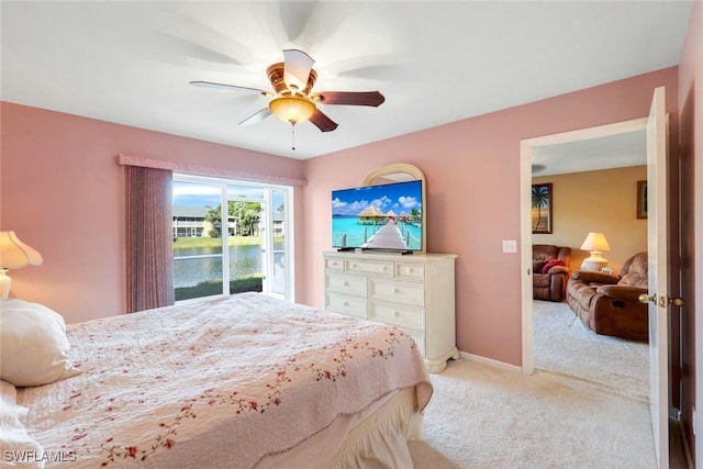 bedroom with light carpet, ceiling fan, and baseboards