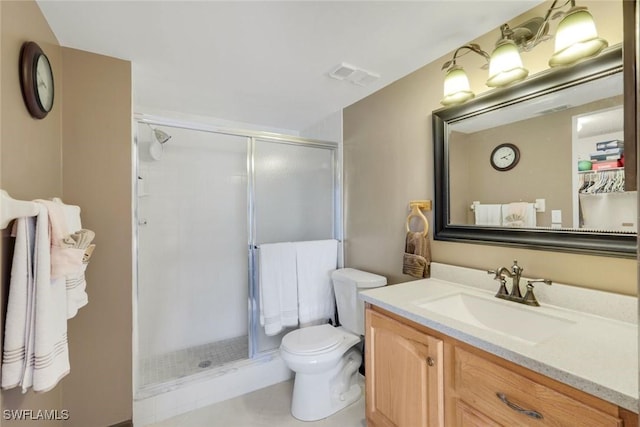 bathroom with a stall shower, visible vents, vanity, and toilet