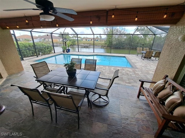 pool with a ceiling fan, a lanai, a water view, and a patio