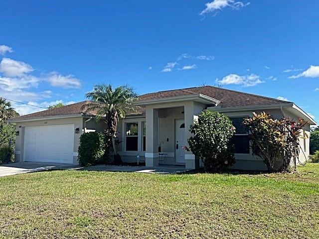 ranch-style house with driveway, a front lawn, an attached garage, and stucco siding