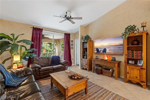 living room with light tile patterned floors, baseboards, vaulted ceiling, and a ceiling fan