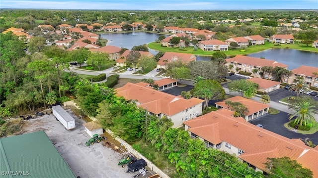 drone / aerial view featuring a water view and a residential view