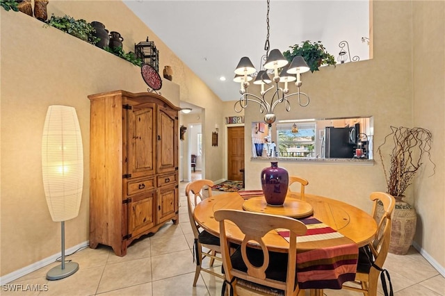 dining space featuring lofted ceiling, light tile patterned flooring, a notable chandelier, and baseboards