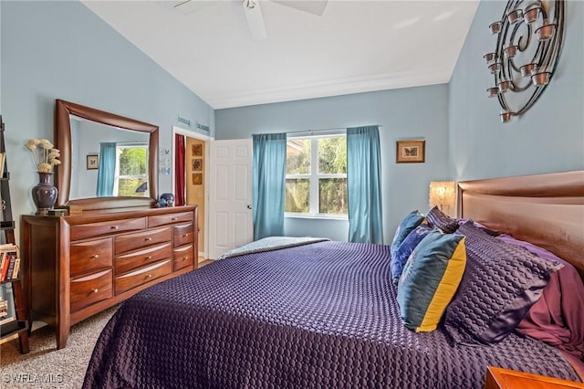 bedroom with lofted ceiling, ceiling fan, and carpet flooring