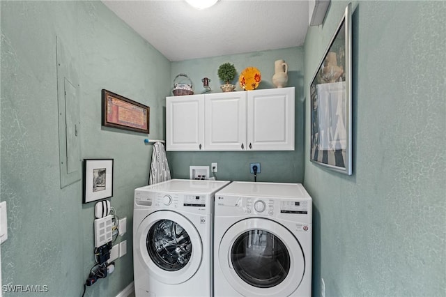 clothes washing area featuring cabinet space and independent washer and dryer