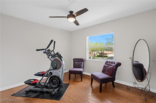 workout room with ceiling fan, baseboards, and wood finished floors