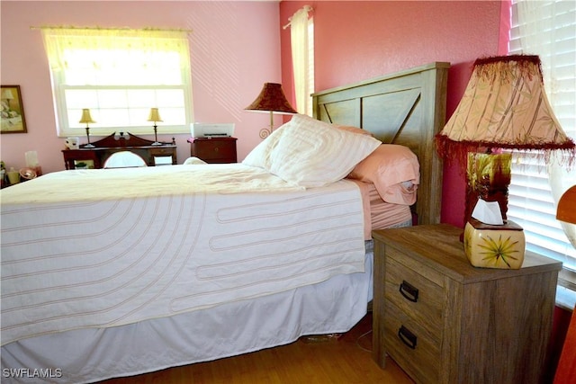 bedroom with wood finished floors