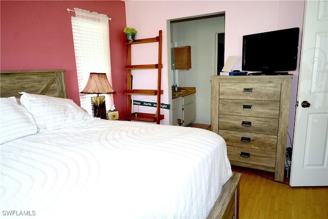 bedroom featuring wood finished floors