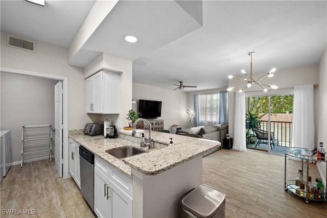 kitchen featuring light wood finished floors, visible vents, white cabinetry, a sink, and dishwasher