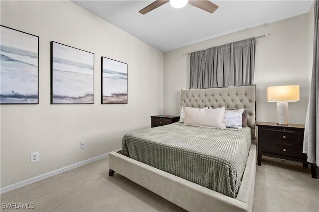 carpeted bedroom with ceiling fan and baseboards