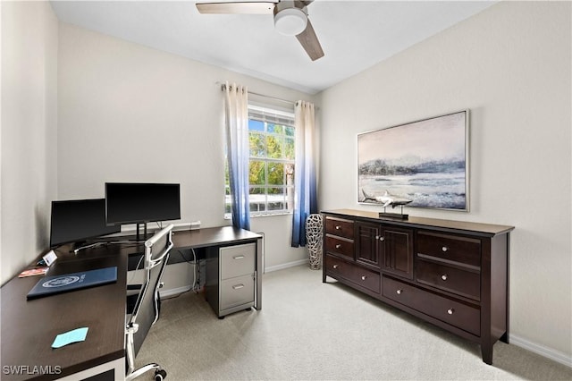 office with a ceiling fan, light colored carpet, and baseboards