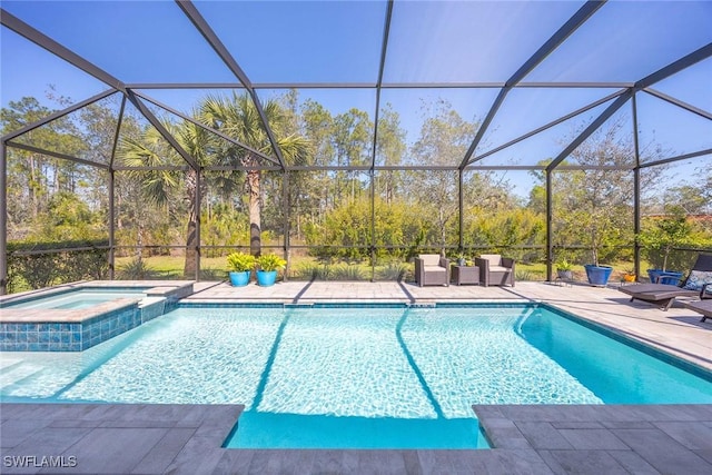 view of swimming pool with a patio and a pool with connected hot tub