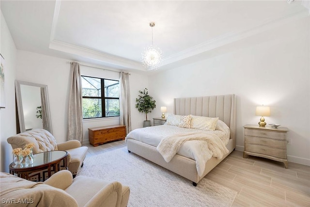 bedroom featuring a tray ceiling, wood finish floors, crown molding, an inviting chandelier, and baseboards