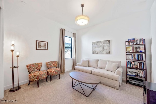 carpeted living area with baseboards