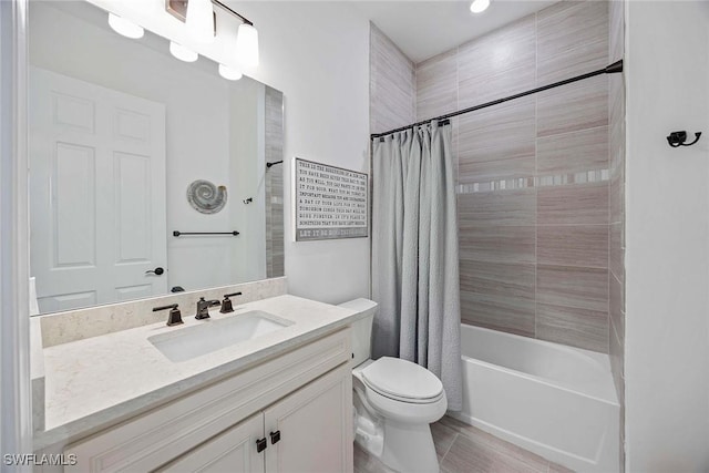 bathroom featuring vanity, toilet, and shower / bath combo with shower curtain