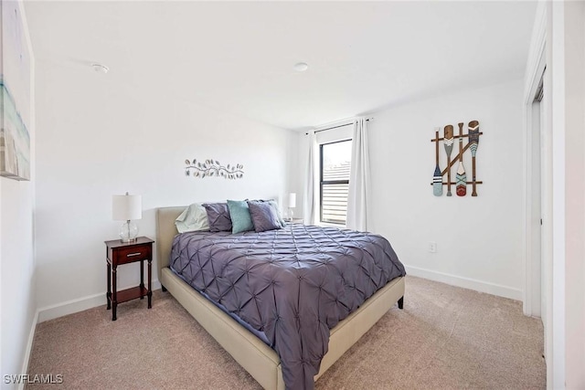 bedroom with carpet floors and baseboards