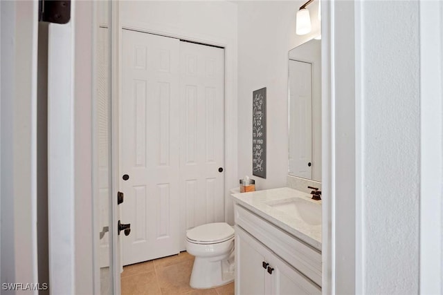 bathroom featuring toilet, vanity, and tile patterned floors