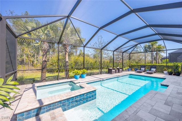 pool with a patio, a lanai, and an in ground hot tub