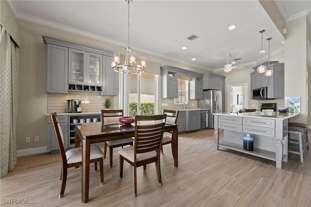 dining space featuring recessed lighting, visible vents, baseboards, wood tiled floor, and crown molding