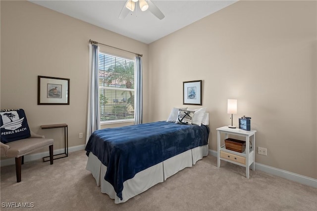 carpeted bedroom with ceiling fan and baseboards