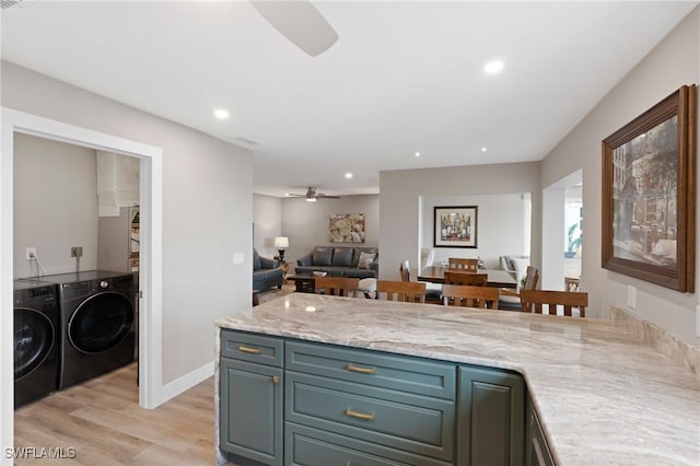 kitchen with open floor plan, a peninsula, washer and dryer, light wood-type flooring, and recessed lighting