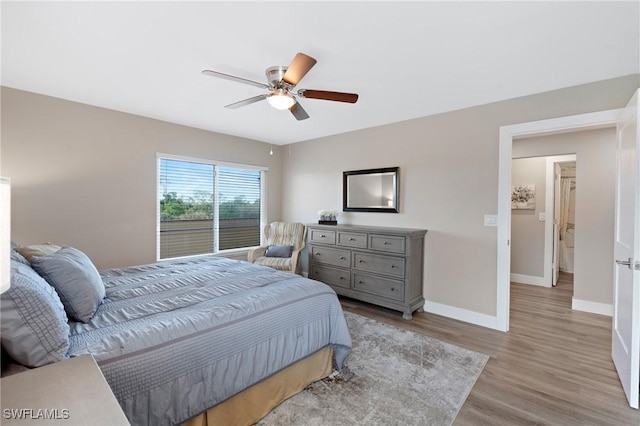 bedroom with ceiling fan, baseboards, and wood finished floors