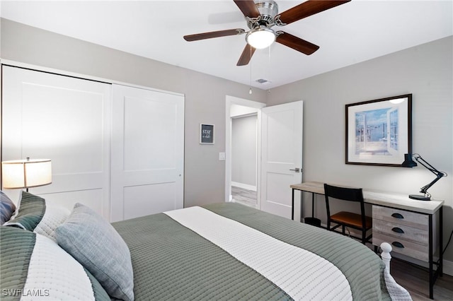 bedroom featuring a closet, visible vents, ceiling fan, wood finished floors, and baseboards