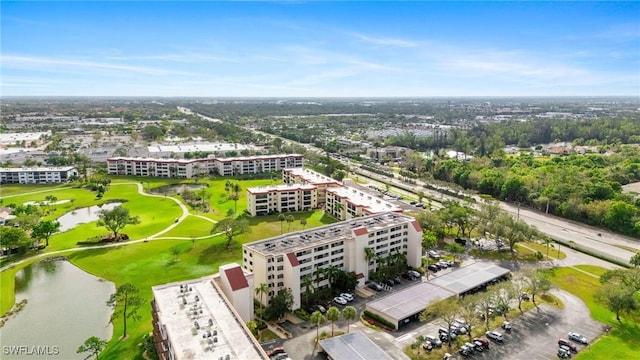 bird's eye view with a water view and golf course view