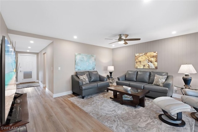 living area featuring recessed lighting, baseboards, ceiling fan, and light wood finished floors