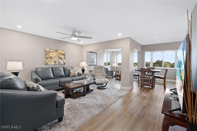 living room with recessed lighting, wood finished floors, a ceiling fan, and a healthy amount of sunlight