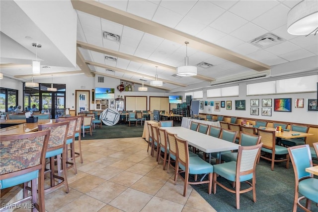 dining room featuring lofted ceiling with beams, light tile patterned floors, and visible vents