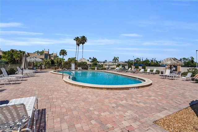 community pool featuring a patio area and fence