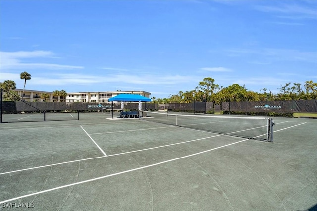 view of sport court featuring fence