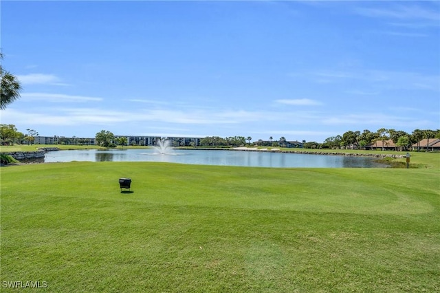 surrounding community with a water view and a yard