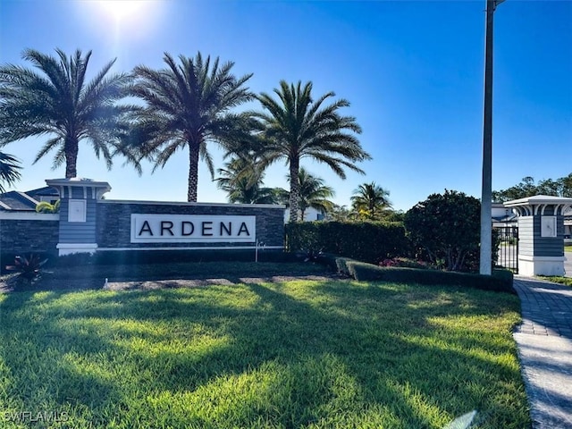 community sign featuring a lawn