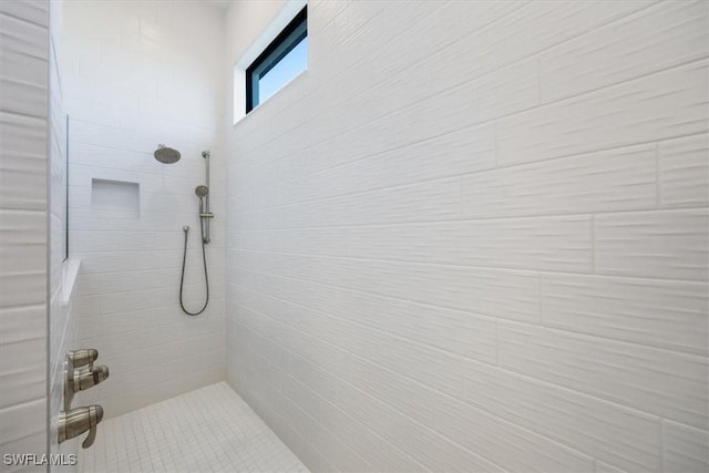 full bath with a tile shower