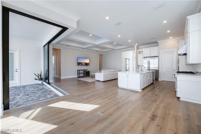 kitchen featuring light wood finished floors, visible vents, open floor plan, stainless steel built in refrigerator, and coffered ceiling