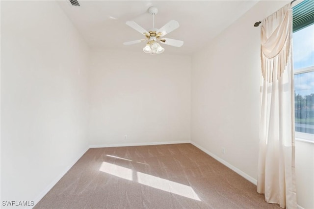 spare room with a ceiling fan, baseboards, and carpet flooring