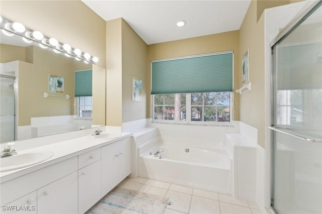 full bath with a bath, a shower stall, a sink, and tile patterned floors