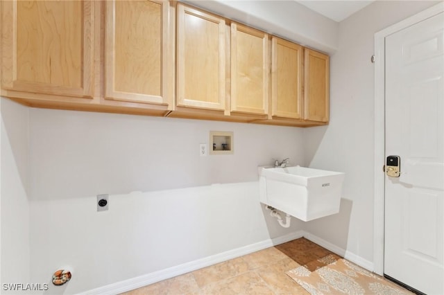 laundry area featuring washer hookup, cabinet space, hookup for an electric dryer, a sink, and baseboards