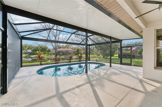 outdoor pool with glass enclosure and a patio