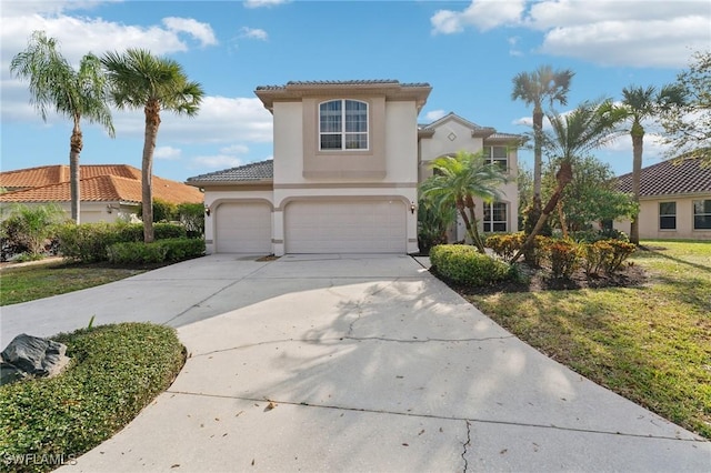 mediterranean / spanish-style home with driveway, a tiled roof, an attached garage, and stucco siding